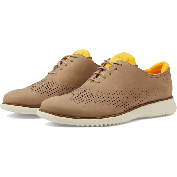 imageCole Haan Mens 2Zerogrand Laser Wingtip OxfordDune NubuckGold FusionIvory